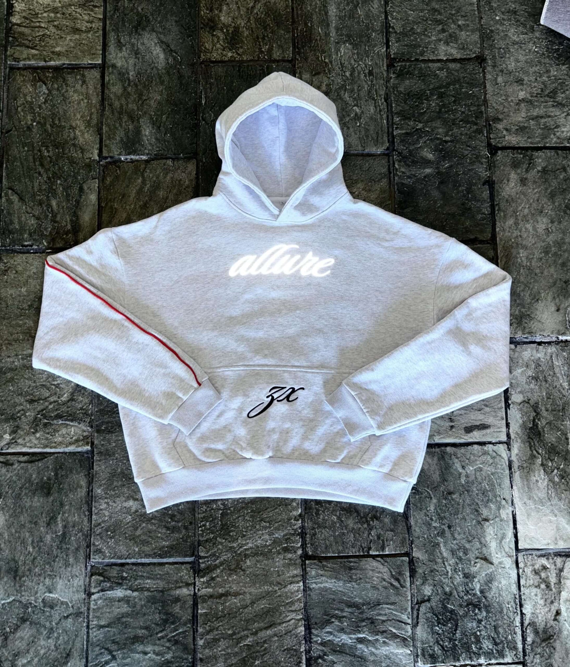 Reflective Allure Hoodie in grey, 100% cotton, featuring red stripes and slim fit design, ideal for luxury tracksuit style.