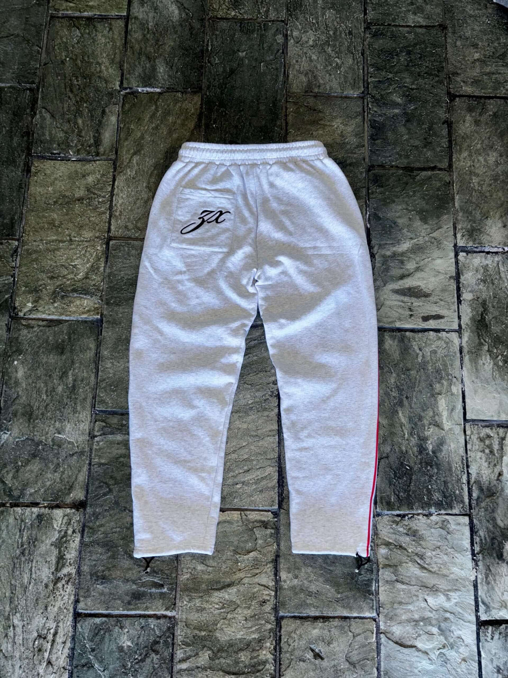 Allure Track Pants in grey cotton with slim fit, red stripes, and embroidery, ideal for luxury athleisure.